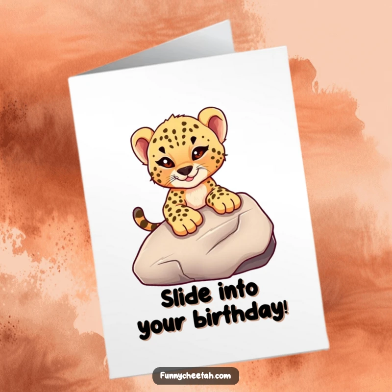 Funny Free Printable Cheetah Cub Birthday Card: Cub with a mischievous wink slides down a large rock, celebrating playfully.