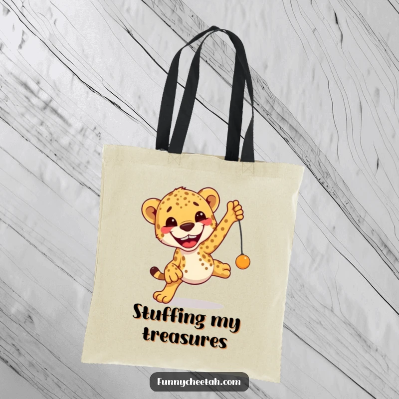 Funny Cheetah Tote Bag depicting an excited cheetah leaping with a huge grin towards a toy, a humorous and practical accessory.